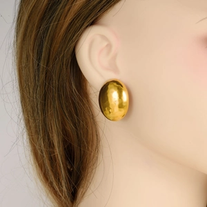304 stainless steel gold oval stud earrings featuring a textured hammered finish on a model