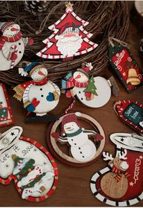 Detail view of painted wooden Christmas ornaments featuring Santa and Snowman themes