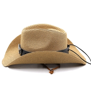 Close-up of straw cowboy hat featuring black leather band and metal badge detail