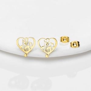 Macro shot of gold heart music note stud earrings with secure butterfly backs