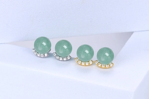 Macro detail of crescent moon earrings with green aventurine beads and sparkling zircons