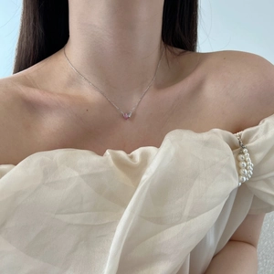 Close-up of S925 sterling silver necklace with pink heart-shaped zircon pendant on model