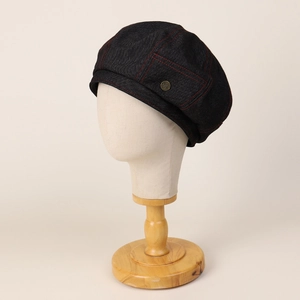 Retro denim beret for women with red contrast stitching and metal button on model head
