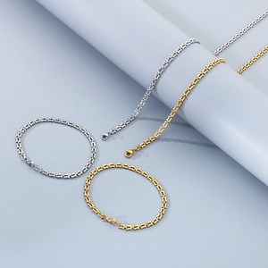 Detailed view of geometric interlocked chain bracelets and necklaces in gold and silver finish