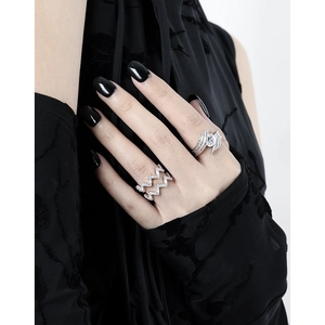 Luxurious wavy hollow silver ring and wing-shaped gemstone ring on model's hand