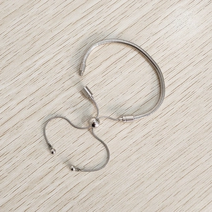 Detail view of silver stainless steel snake chain bracelet with adjustable bolero slider