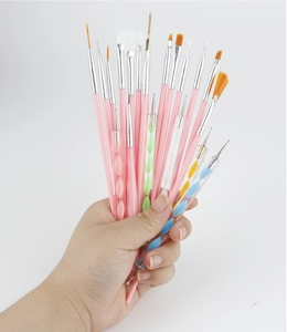 Detailed close-up of 15 professional nail art brushes with pink and spiral acrylic handles