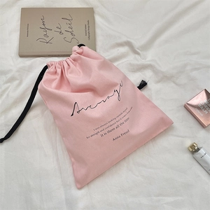 Pink cotton linen drawstring storage bag with inspirational quote on white fabric