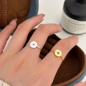 Macro shot of 925 sterling silver starburst rings in gold and silver with red gemstones