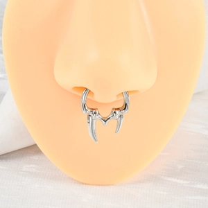Macro view of silver U-shaped non-pierced nose ring in a unique tusk design