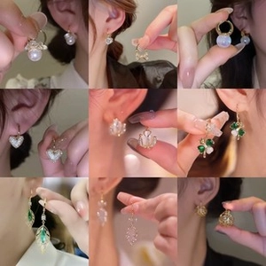 Collection of 18K gold-plated butterfly and faux pearl earrings with diverse elegant designs