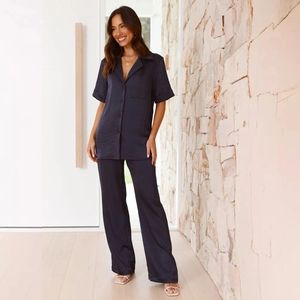 Detail of dark blue satin loungewear set featuring short sleeves and button-down collar