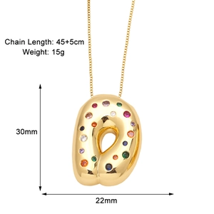 Macro shot of gold D-letter pendant with colorful round zircons and detailed measurements