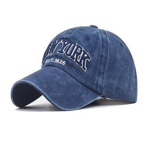 Detail of navy blue washed cotton baseball cap with white 3D New York embroidery