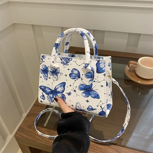 Elegant white crossbody handbag with blue butterfly print for daily commute styling
