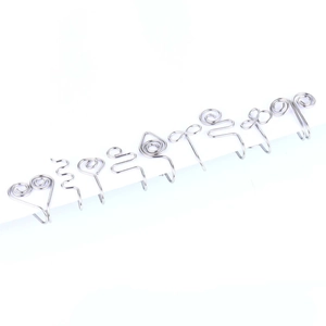 Flat lay of 10 stainless steel U-shaped clip-on nose rings with various wire art designs