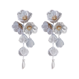 Elegant silver flower tassel earrings with zircon petals and gold centers on white background