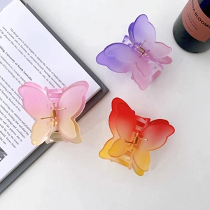 Three gradient frosted butterfly hair clips in purple pink and orange resin with metal spring