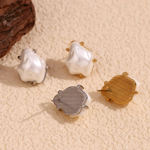Luxury baroque faux pearl stud earrings in gold and silver plating on matte surface