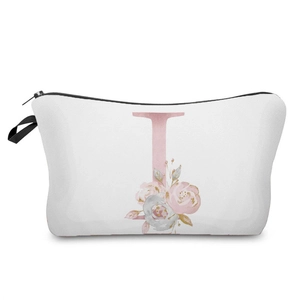 Macro view of elegant pink floral letter I printed on a white cosmetic storage pouch