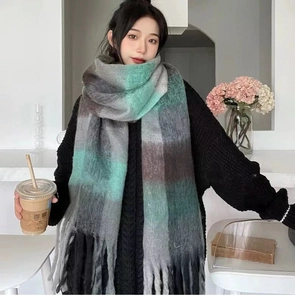 Detail of soft rainbow plaid scarf with mint green and brown tones and long fringes