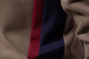 Close-up of high-density knitted fabric showing brown, red, and navy striped stitching