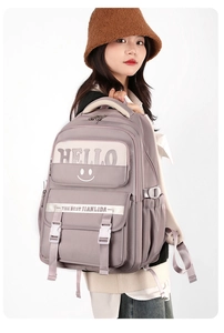 Side view of student nylon backpack in dusty pink featuring adjustable buckles and pockets