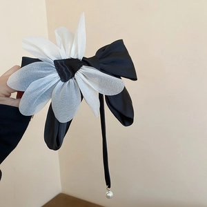 Elegant large black ribbon hair bow with white petals and a delicate pearl pendant