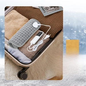 Foldable grey heating pad in luggage showing 58x29cm size for portable travel use