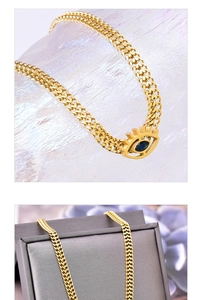 Detail of gold woven chain and blue evil eye pendant on a luxury jewelry box