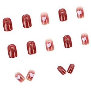 Short square dark red press-on nails with white heart patterns and a glossy finish