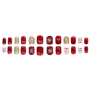 Faux ongles festifs dorés pailletés cerf de Noël avec motifs rouges et flocons de neige