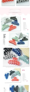 Detail showing five colors of large glitter hair claws with black butterfly pattern prints