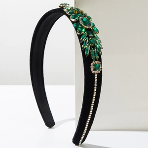 Detail of emerald green crystals and rhinestones on black velvet headband