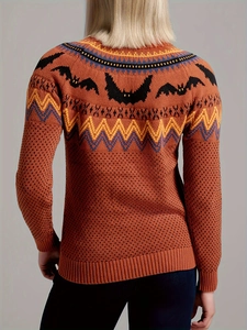 Oversized orange knit sweater featuring black bat patterns and colorful geometric motifs