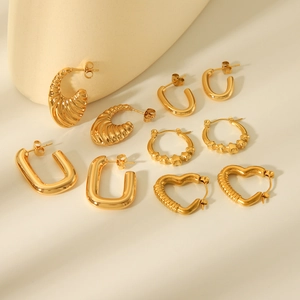 Collection of golden stainless steel earrings featuring heart and geometric shapes