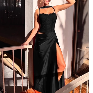 Detail of elegant black lace corset with boning and sleek satin high-slit evening skirt