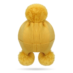 Vibrant yellow knit earflap hat for kids with three large fluffy faux fur pom-poms