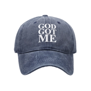 Vintage washed navy blue baseball cap with white GOD GOT ME text on a white background