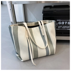 Detailed view of large vertical striped canvas tote bag with reinforced handles