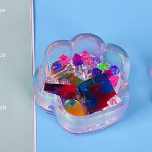 Detailed view of cat paw silicone storage mold filled with colorful resin jewelry charms