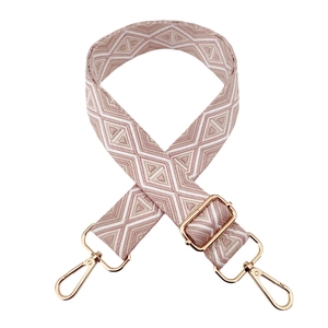 Detail of bohemian geometric pattern bag strap with golden metal swivel hooks