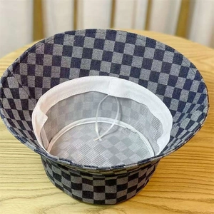 Detail showing checkered denim bucket hat interior with adjustable drawstring and sweatband