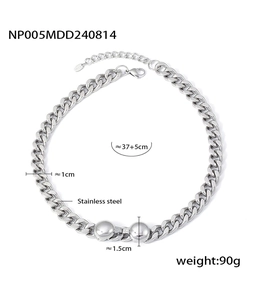 Close-up of silver stainless steel Cuban chain necklace with two polished metal ball pendants