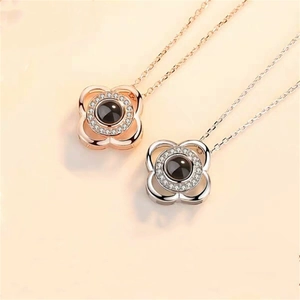 Detail of rose gold and silver clover necklaces with black stones and pave crystals