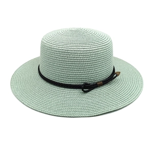 Close-up of fine woven straw texture and vintage bronze metal buckle on wide brim hat