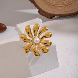 Detailed view of a gold flower open ring with a white pearl on a decorative column