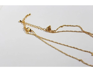 Detailed view of the gold-plated lobster clasp and adjustable extension chain