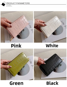 Four long croc-effect wallets in pink, white, green, and black with metal zippers