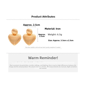 Detail of gold heart-shaped textured earrings with silver pins and size measurements